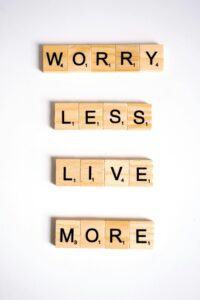 Motivational quote made from Scrabble tiles on a white background, inspiring positivity.
