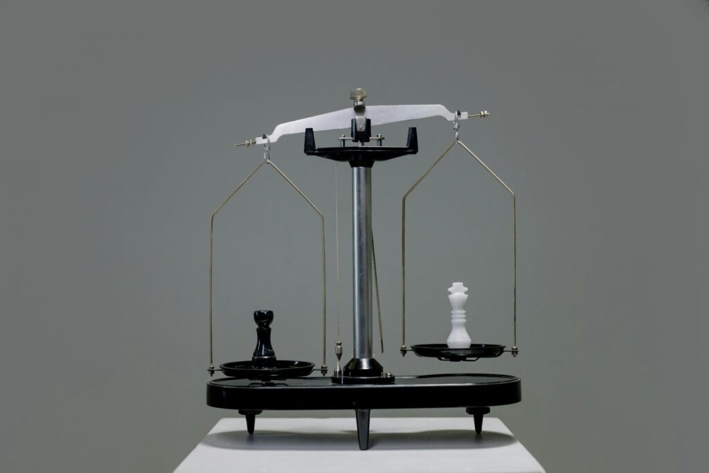 Chess pieces balanced on a scale depicting equality or strategy in decision making.